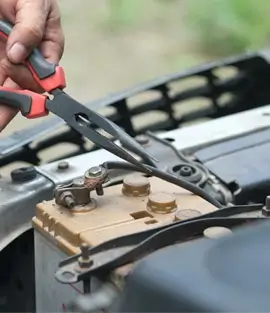 Replace a car battery using a tool
