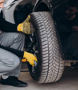 Mechanic doing Car Tyre Replacement Services