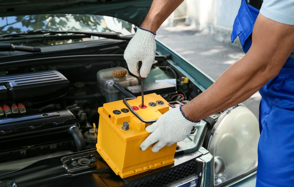 Mechanic Fixing Car Battery